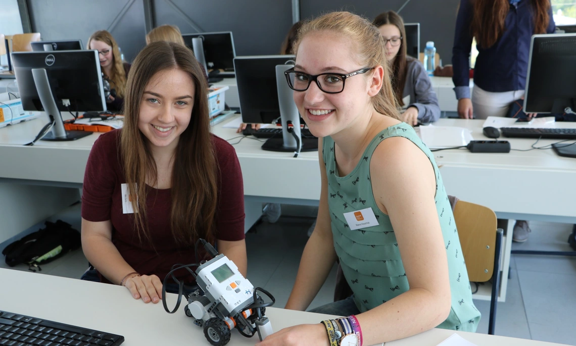 Two girls with a little robot